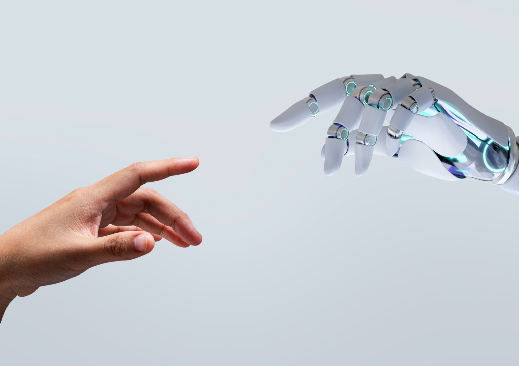 A human hand reaching towards a robotic hand